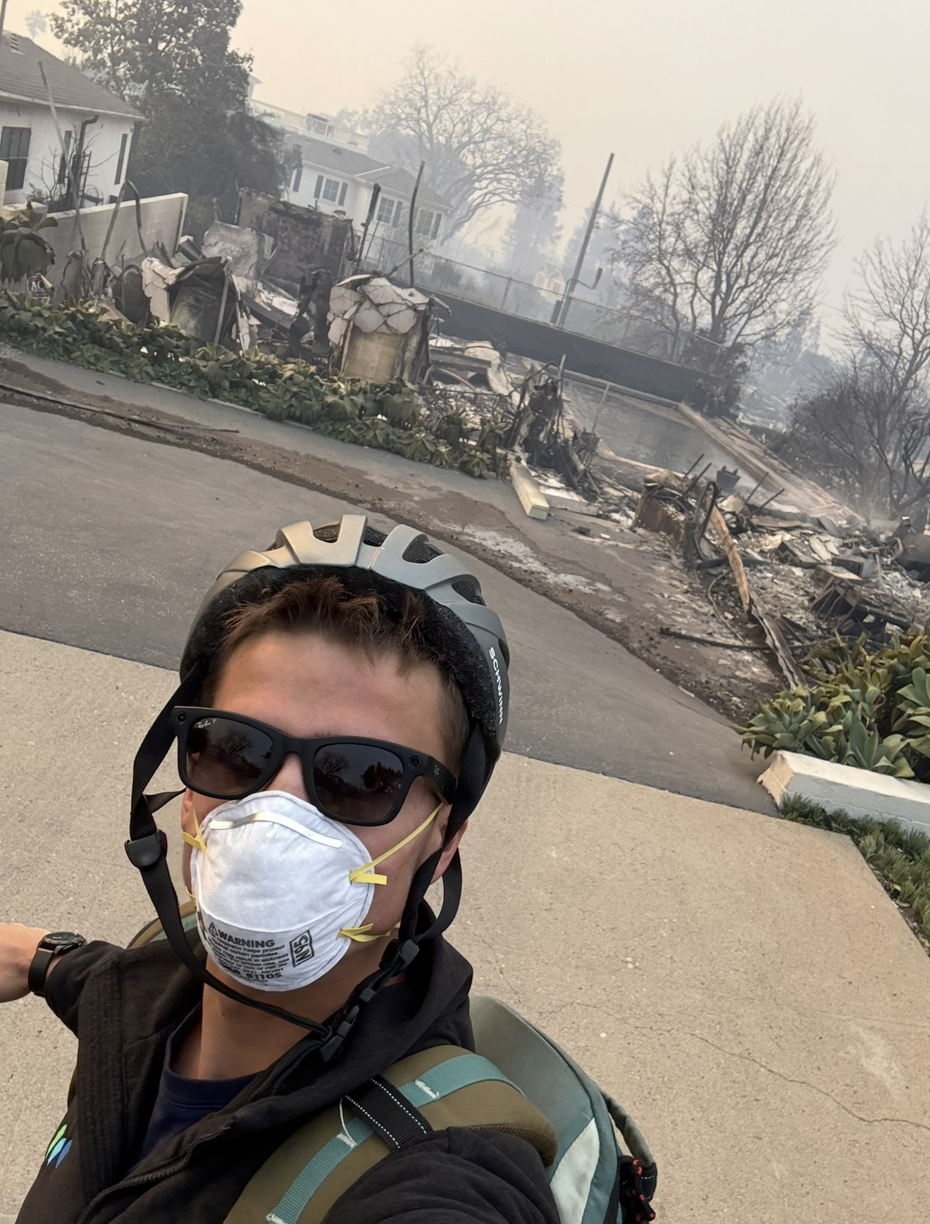 Miles in front of his burned childhood home, day after the Palisades fire
